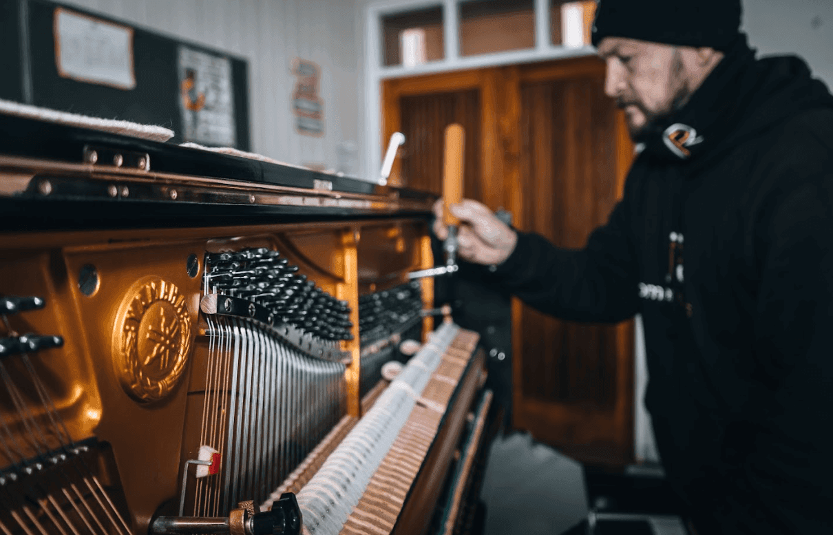 Afinador ajustando las cuerdas de un piano